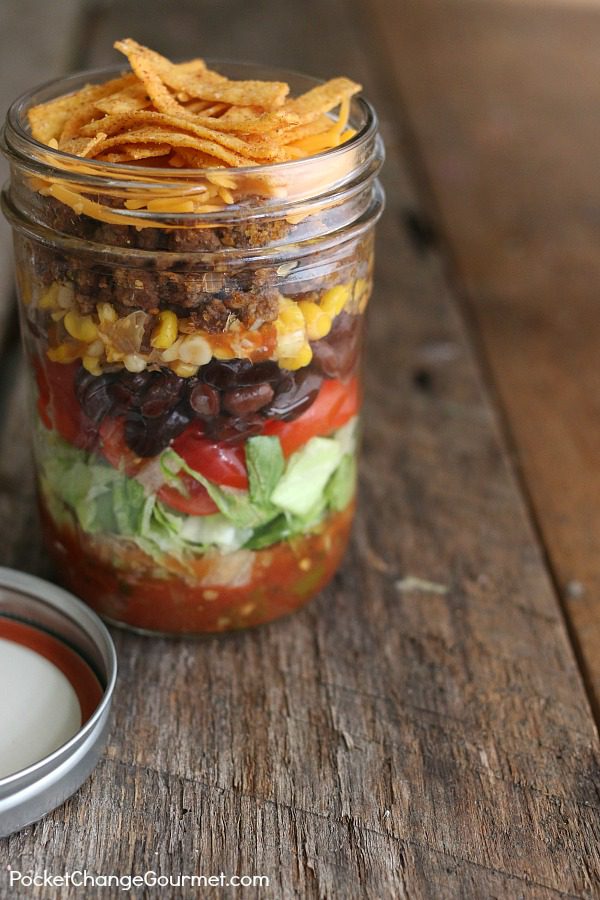 Taco Salad in a Jar -- This quick and easy lunch recipe is not only delicious, it's packed with healthy food! Layers of lettuce, tomatoes, beans and more! 