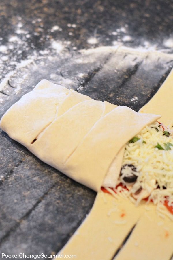 This twist on pizza makes a fun Halloween Dinner Recipe for your family, friends, to serve at a Halloween Party or take to the office. It has all your favorite pizza topping inside the dough, wrapped up to make a Mummy Calzone! 