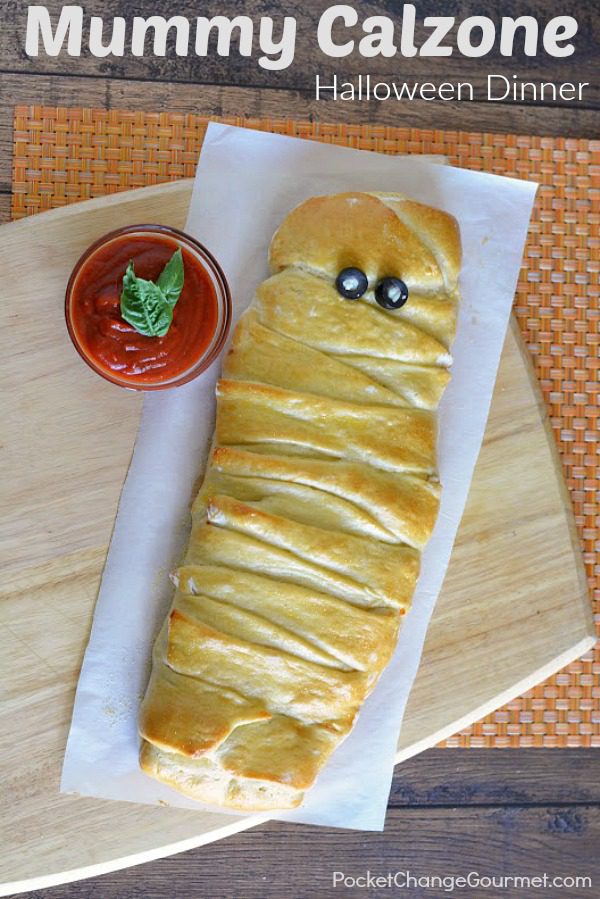 This twist on pizza makes a fun Halloween Dinner Recipe for your family, friends, to serve at a Halloween Party or take to the office. It has all your favorite pizza topping inside the dough, wrapped up to make a Mummy Calzone! 