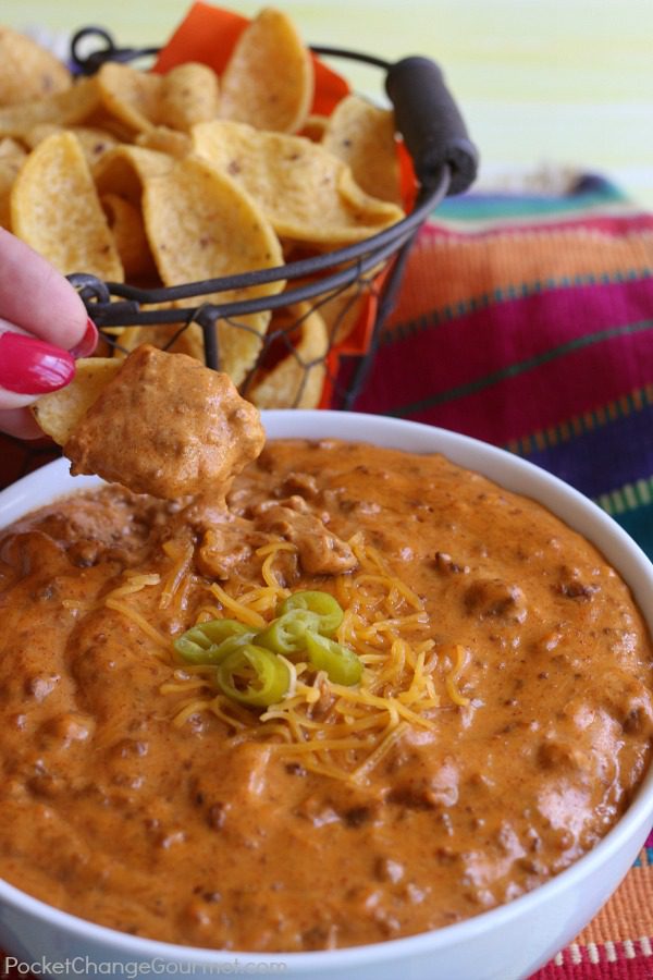 The BEST Chili Cheese Dip - This long time family favorite recipe has only 5 ingredients and is heated in the microwave for 5 minutes. This dip is gobbled up every time I make it! Be sure to save by pinning to your Recipe Board!