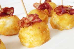 chicken croquettes topped with bacon bits