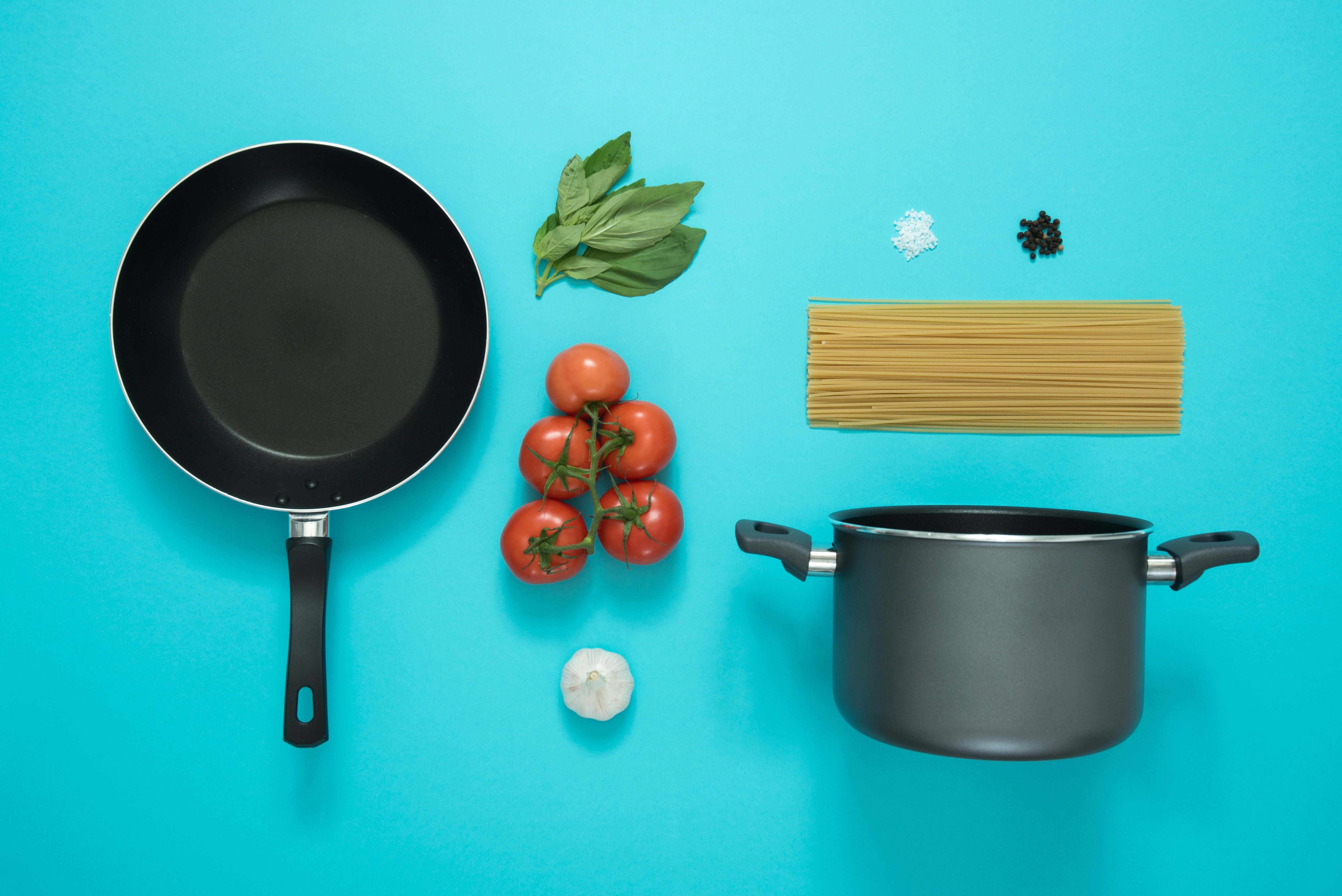 non-sticky frying pan, casserole pot and fresh pasta ingredients
