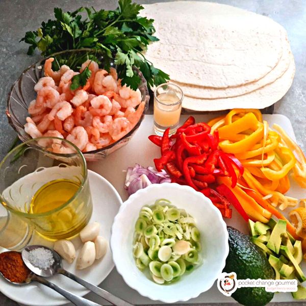 ingredients of shrimp fajitas place in bowls and board