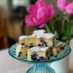cut blueberry lemon bars on cake stand