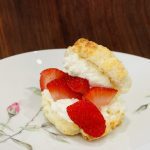 A fluffy Gluten-Free Shortcake is stuffed with strawberries and whipped cream.